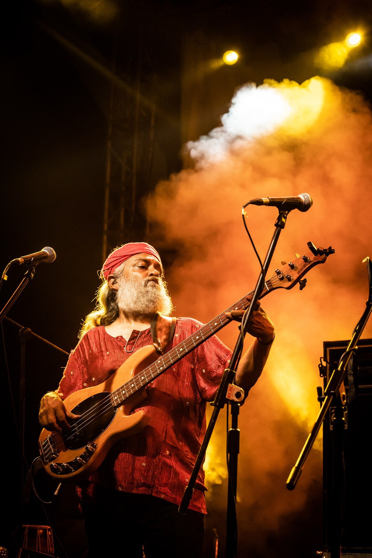 Zevela Creative event — bassist in orange stage smoke