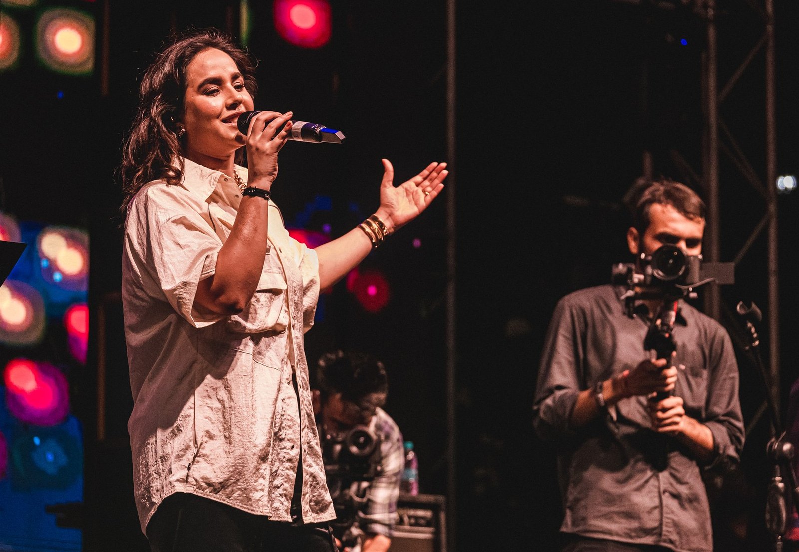 Zevela event — vocalist performing with crew filming